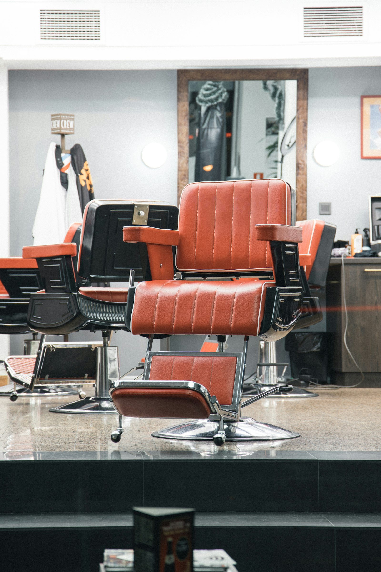Red leather barber chairs inside the shop
