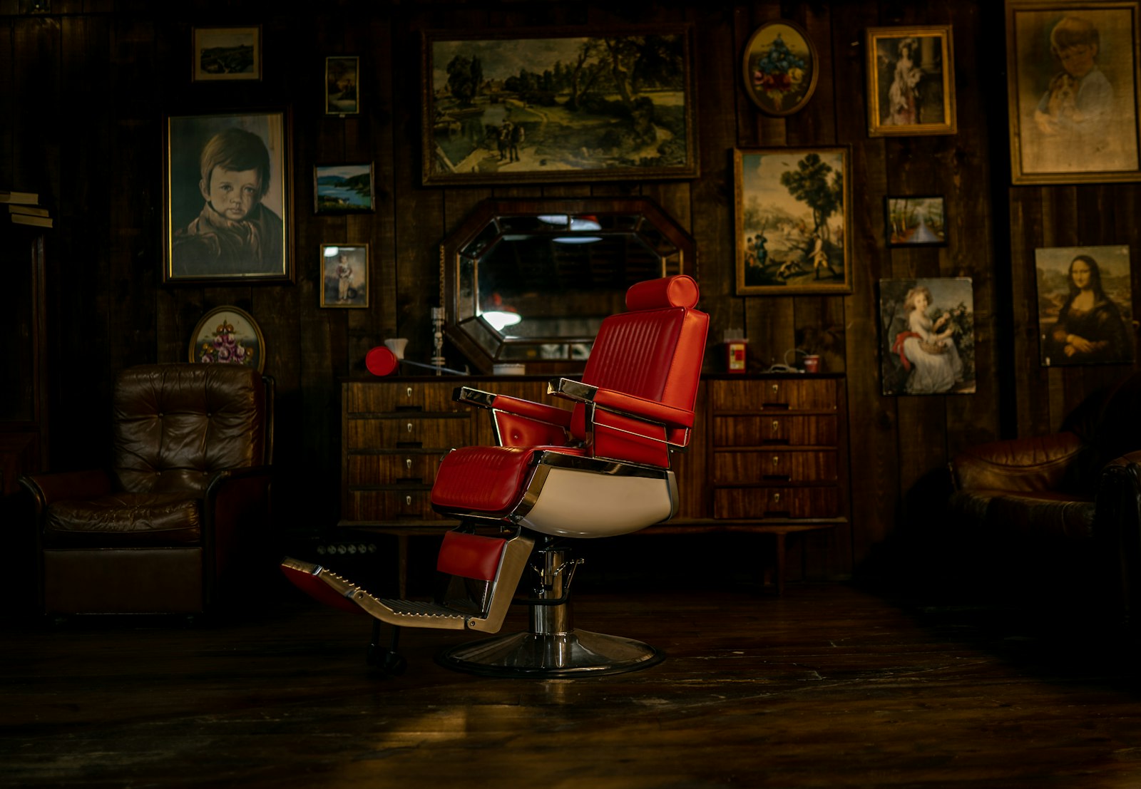 Vintage red barber chair under warm light at Southpaw Barber Club