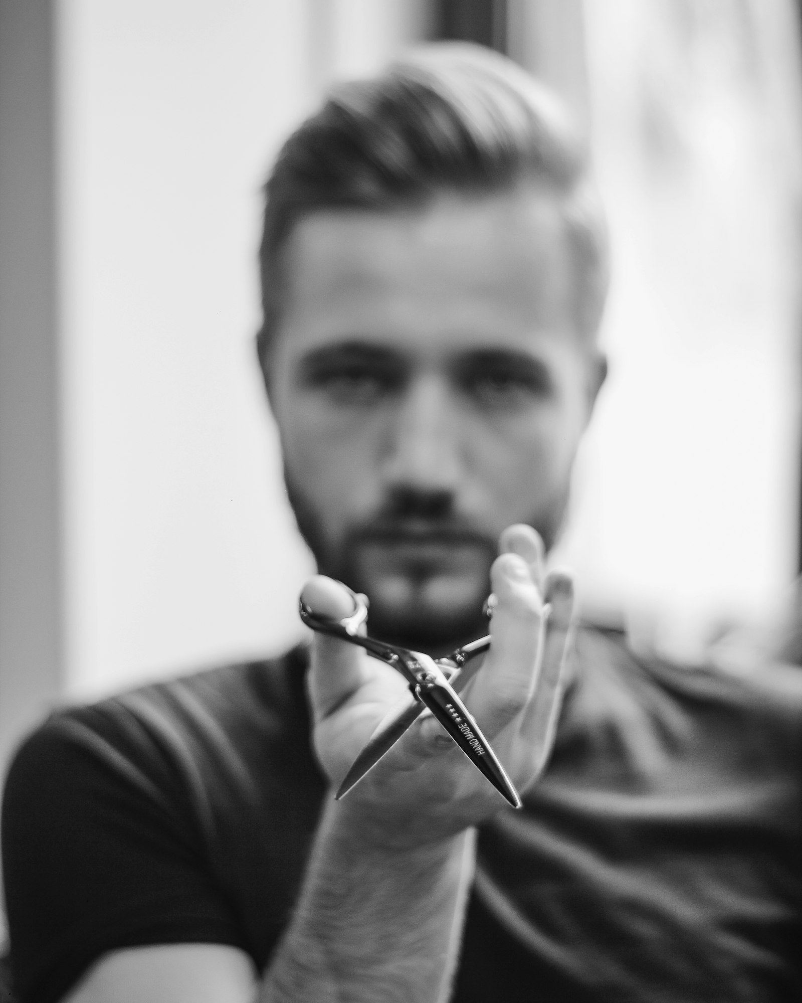 Barber holding hand-made shears