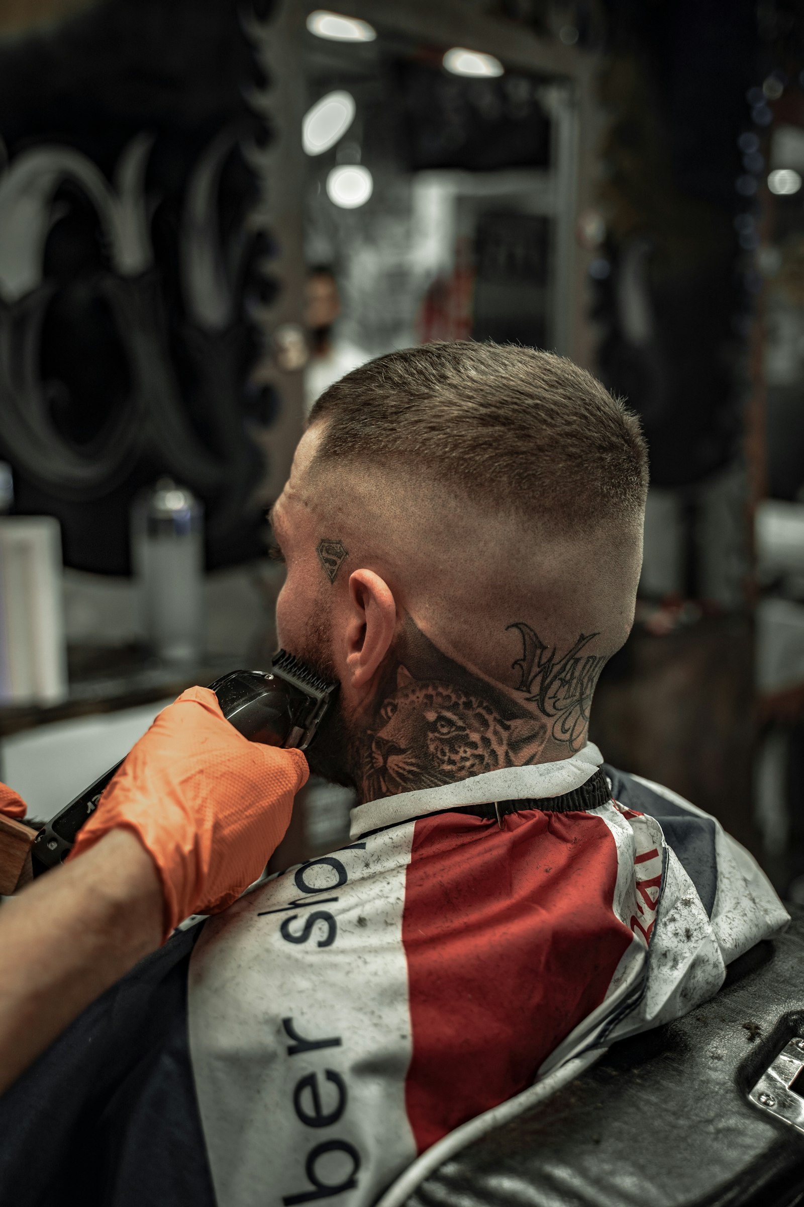 Finished skin fade, tattooed client