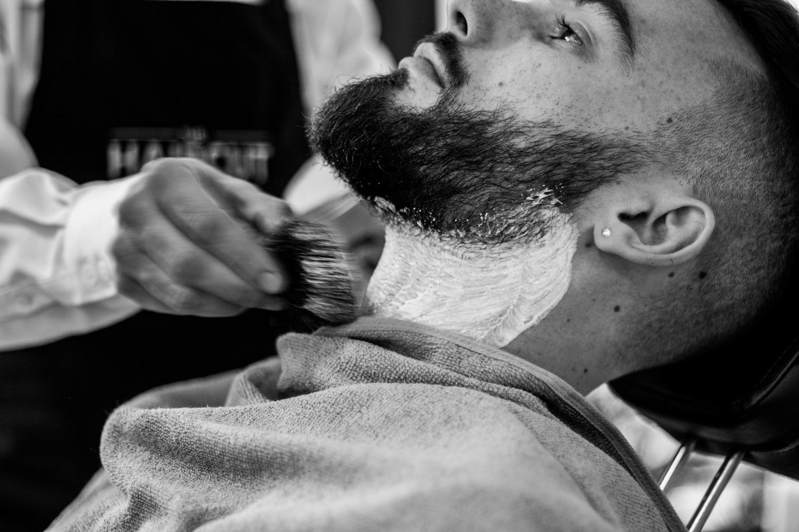 Hot lather brushed on before the razor